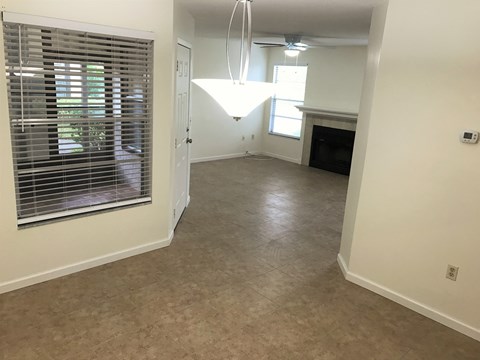 a view from the kitchen into the living room and dining room