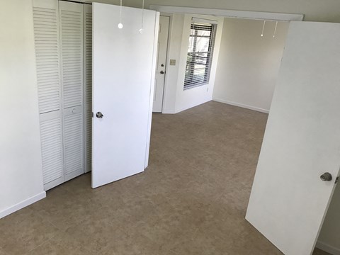an empty room with a closet and a door