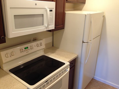 a kitchen with a stove microwave and refrigerator