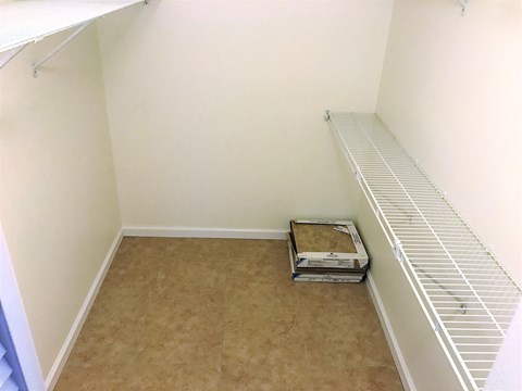 a room with a closet and a shoe box on the floor
