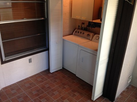 the laundry room has a washer and dryer and a window