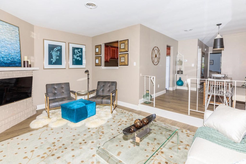 a living room with a fireplace and a glass table