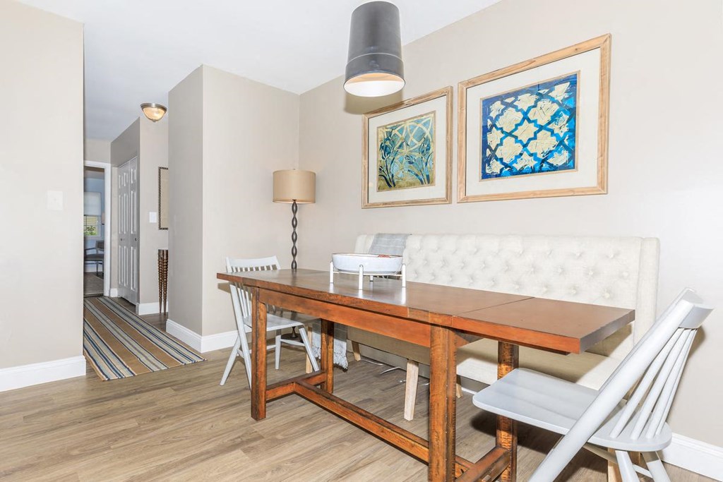 a dining room with a wooden table and chairs