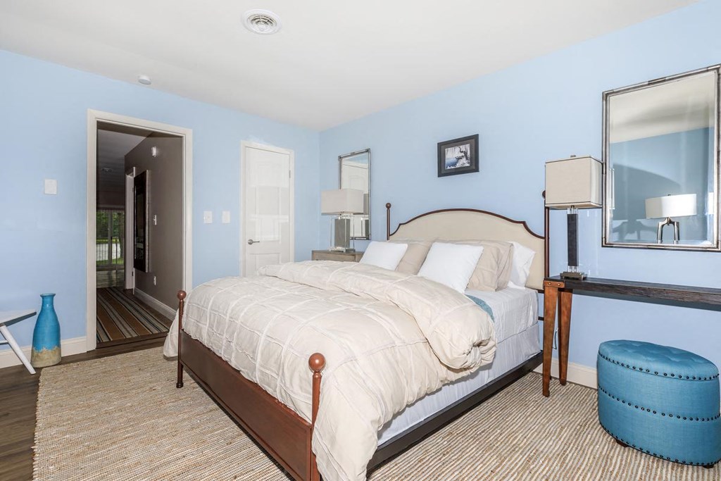 a bedroom with a bed and a mirror