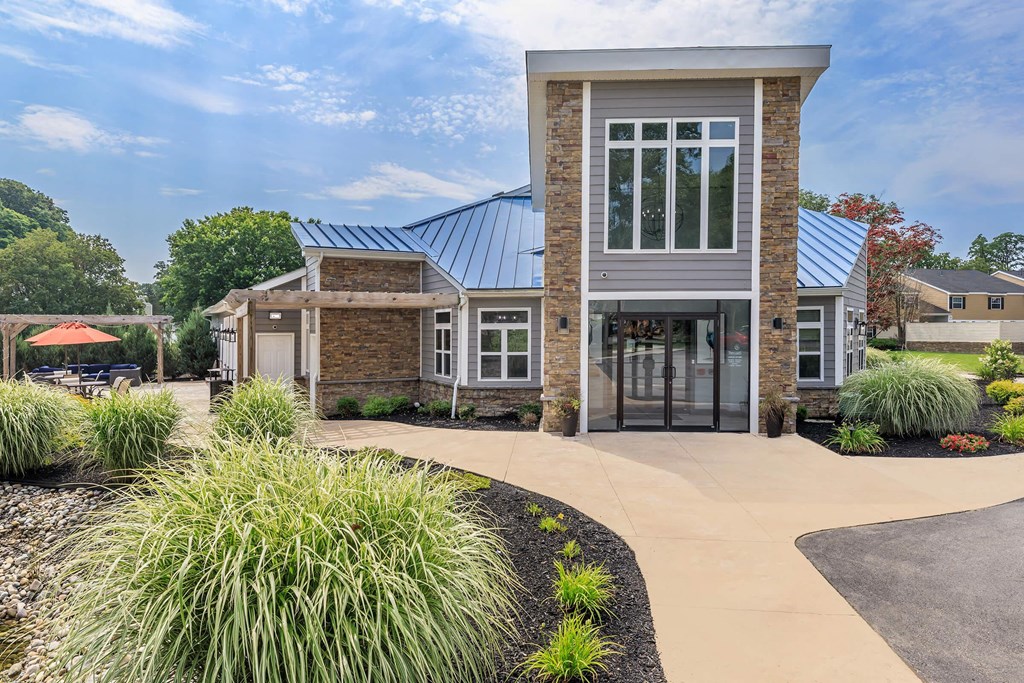 the front of a house with a walkway and a driveway
