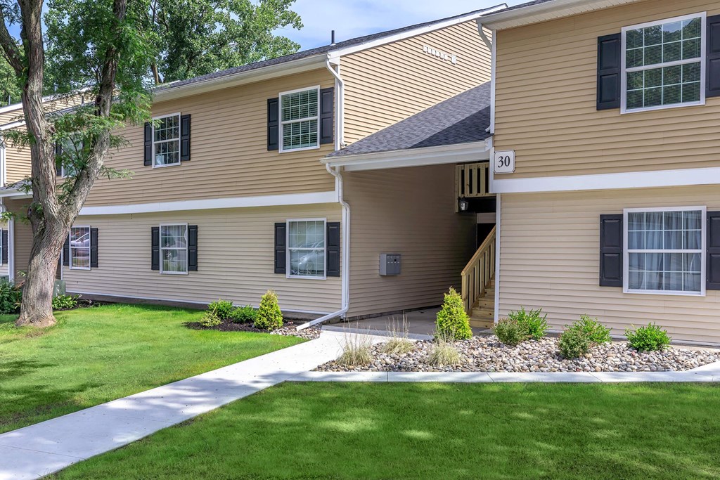 the front of a house with a yard and grass