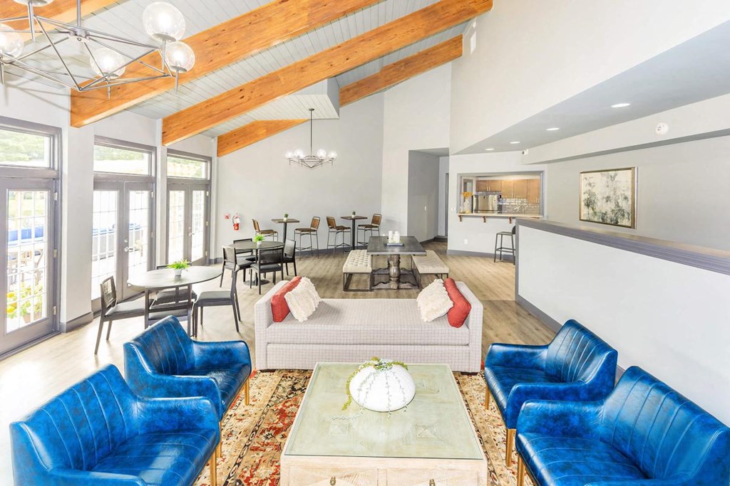 a large living room with blue chairs and a couch