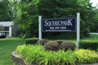 a sign for square park in front of a yard