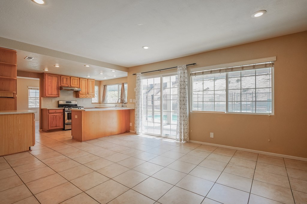 a large kitchen with a sliding glass door to the patio