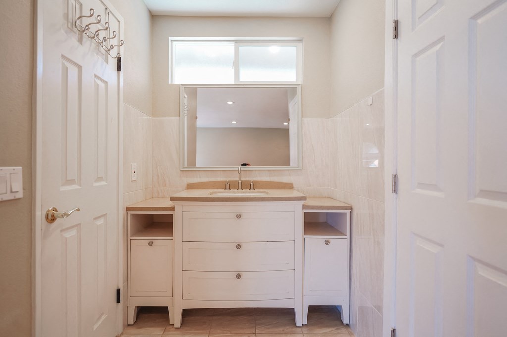 a small bathroom with a sink and a mirror