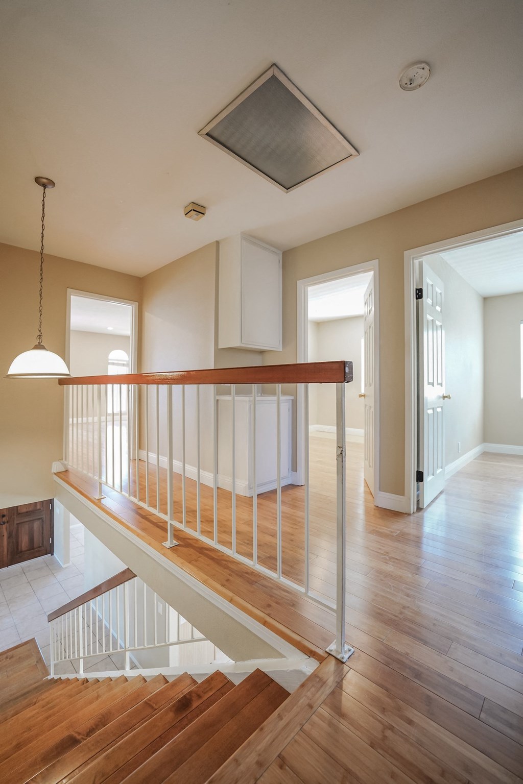 a view of a staircase in a home with wood floors and white walls