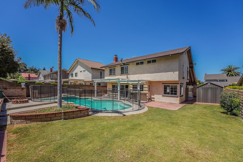 a backyard with a pool and a house