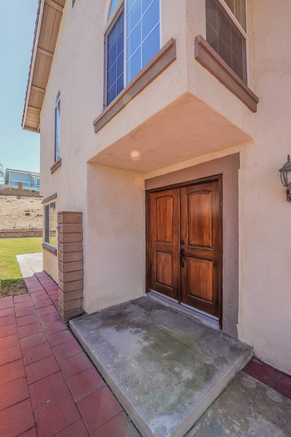 the front entrance to a house with a wooden door