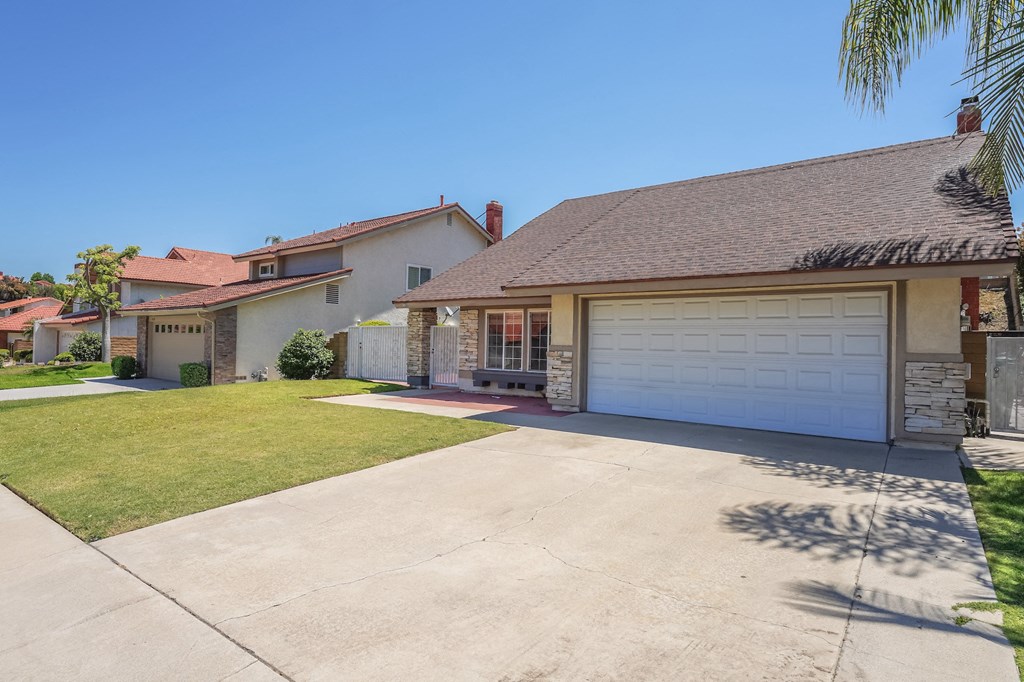 a white house with a driveway and a garage door