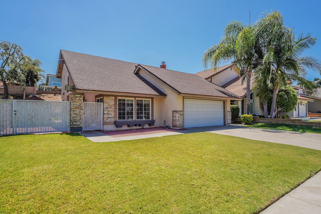 a house with a lawn and a blue garage door