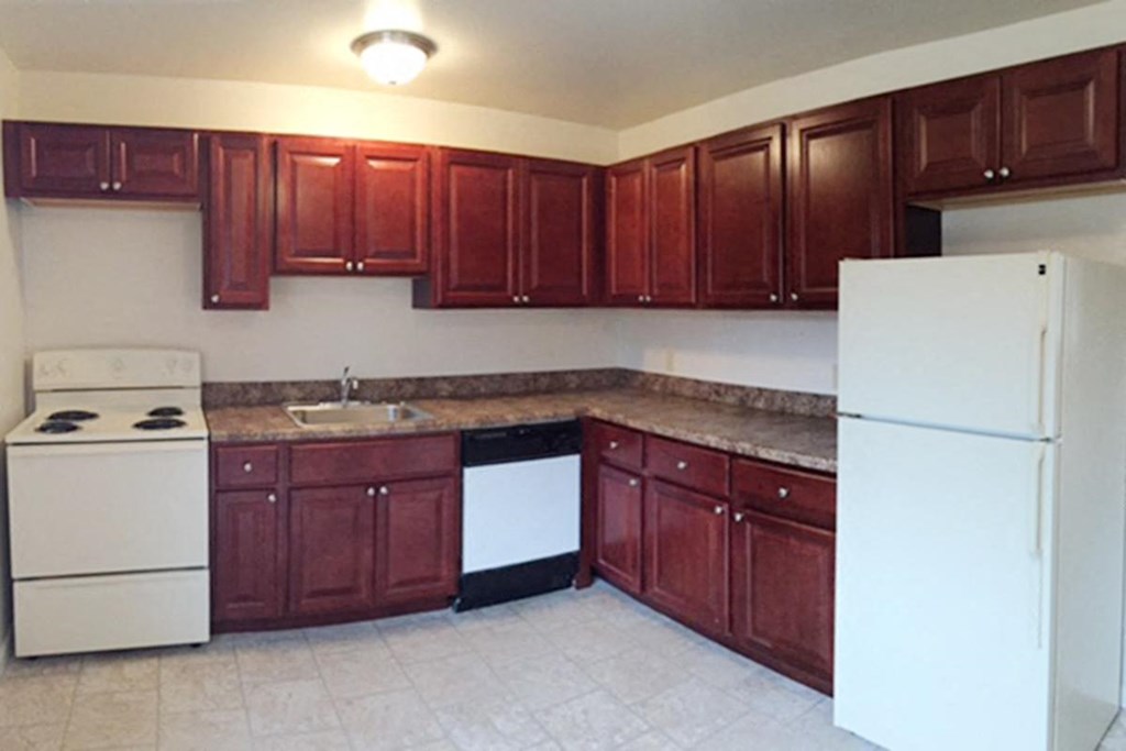 a kitchen with wooden cabinets and a white refrigerator