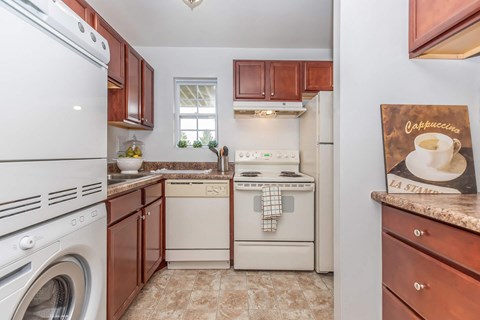 a kitchen with white appliances and wooden cabinets