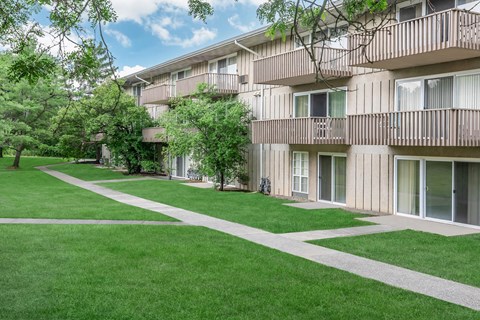 our apartments have a spacious courtyard with green grass and trees