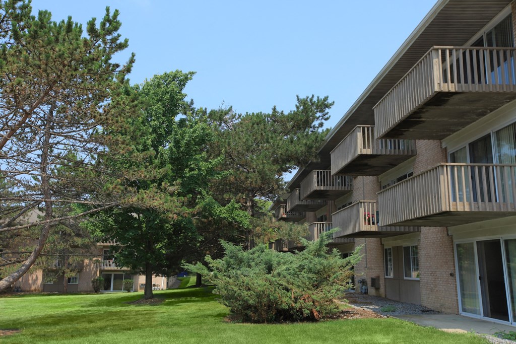 a view of a building with trees in front of it