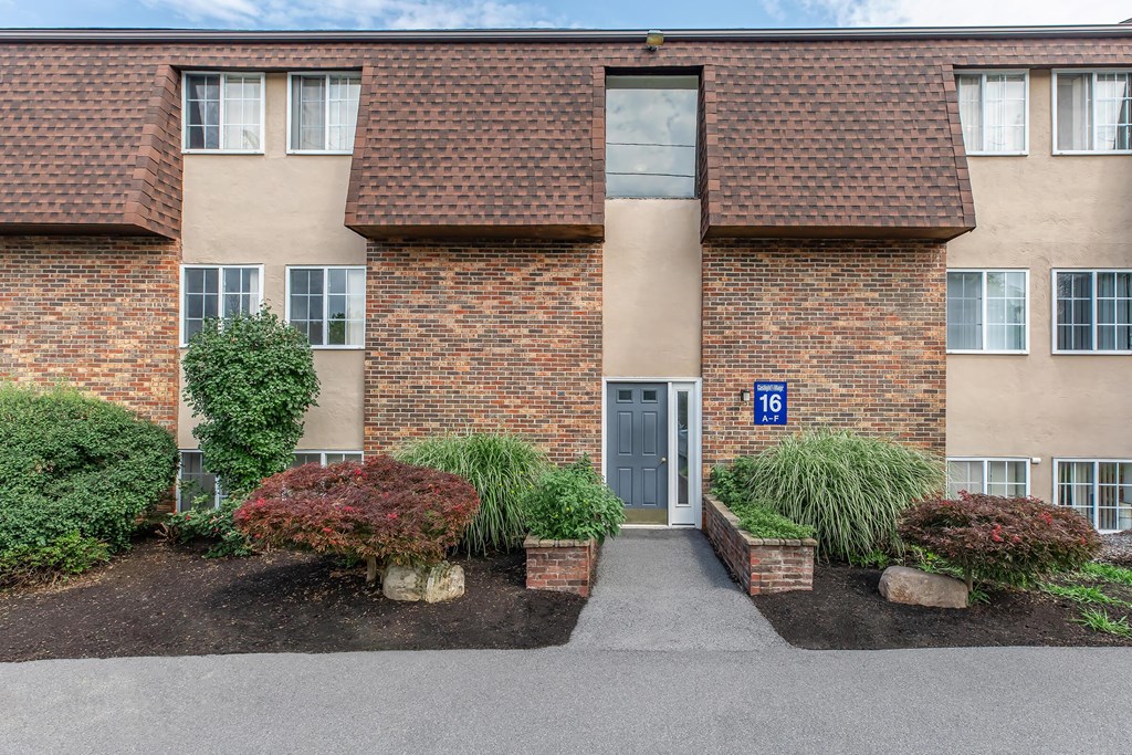 the front of a brick building with a blue door