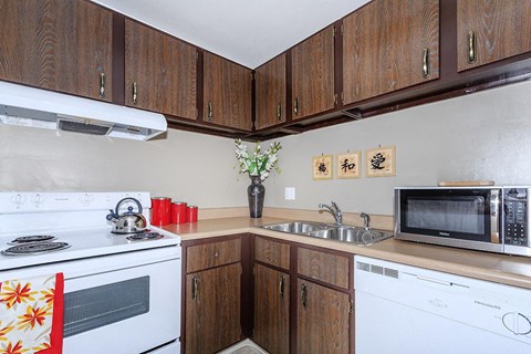 a kitchen with a stove microwave and sink