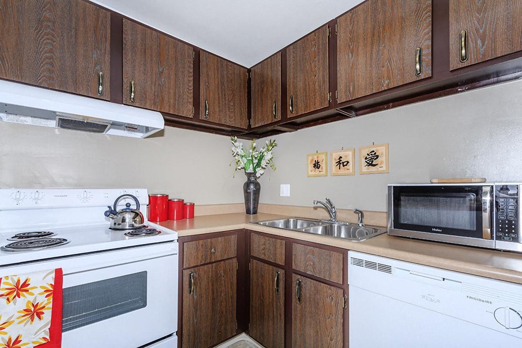 a kitchen with a stove microwave and sink