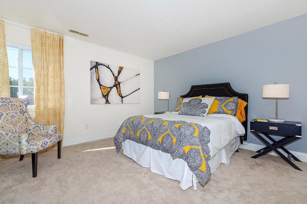 a bedroom with a bed and a chair