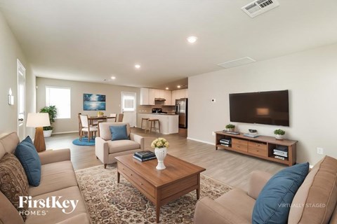 A living room with a brown couch and a wooden coffee table.