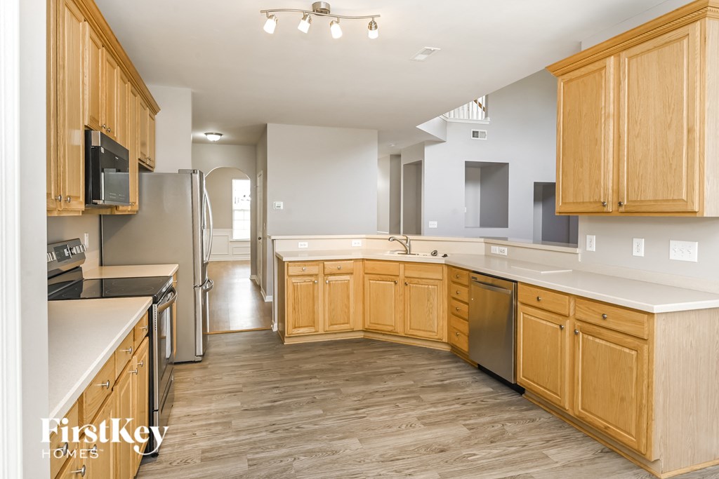 a kitchen with wooden cabinets and stainless steel appliances