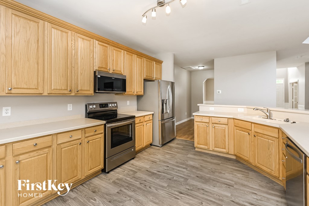 a kitchen with wooden cabinets and stainless steel appliances