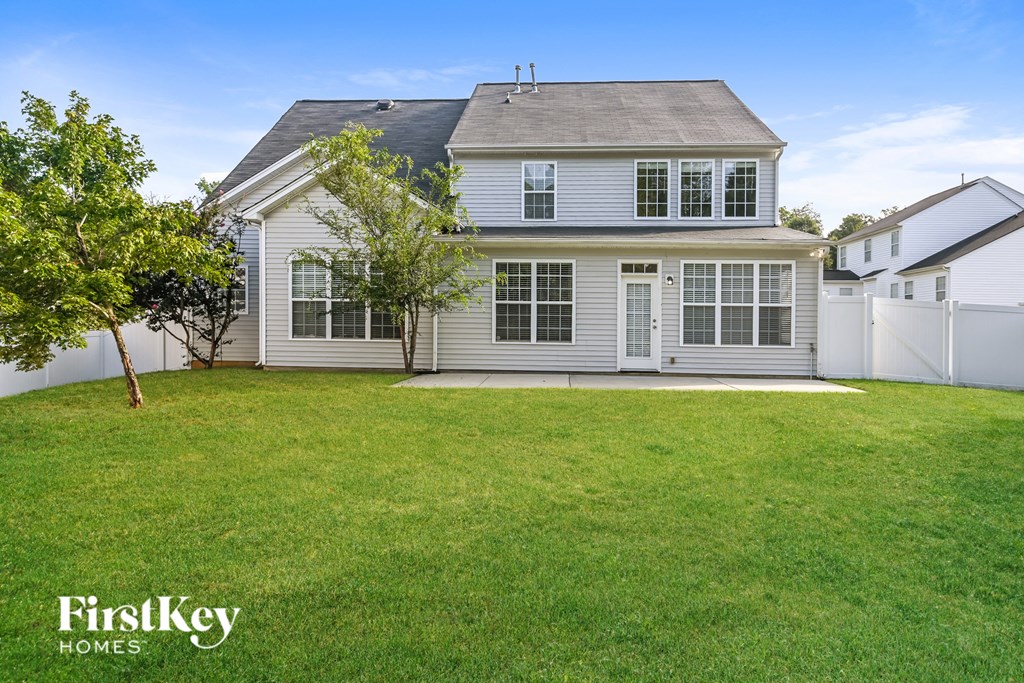 a white house with a lawn in front of it