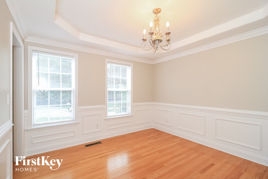 A room with wooden floors and a chandelier.