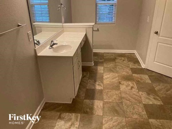a small bathroom with a sink and a mirror