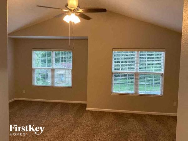 a living room with a ceiling fan and a window