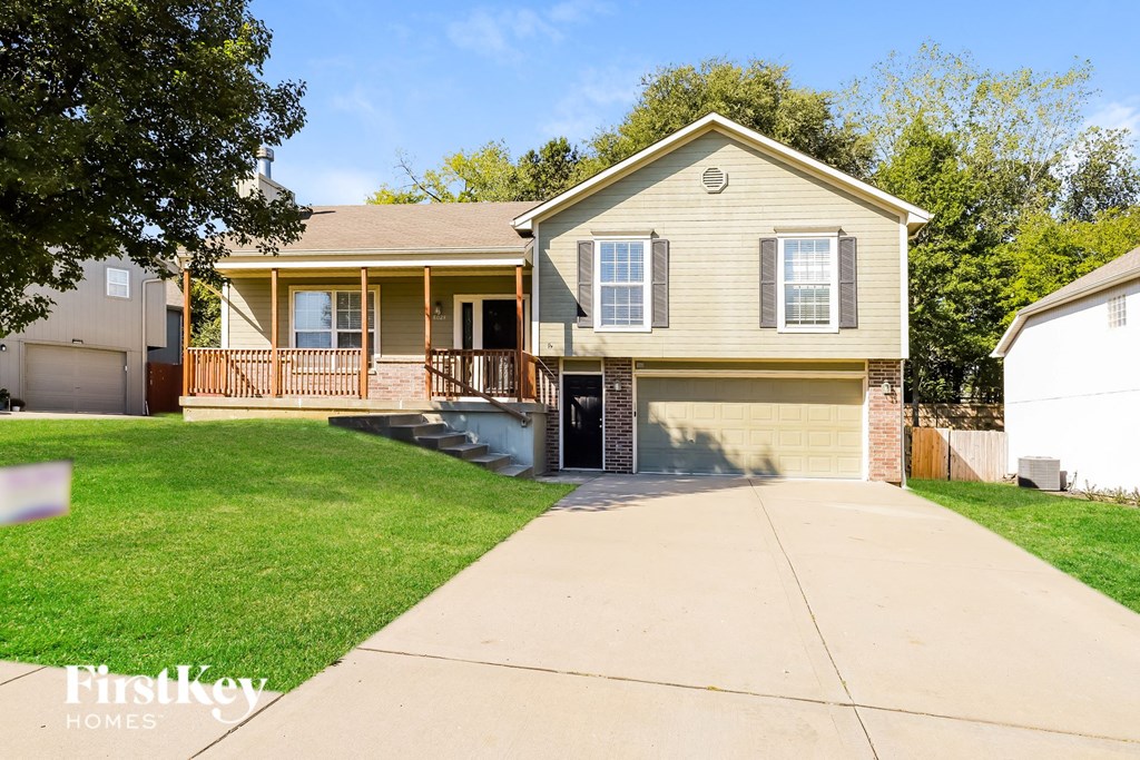 a beige house with a sidewalk in front of it