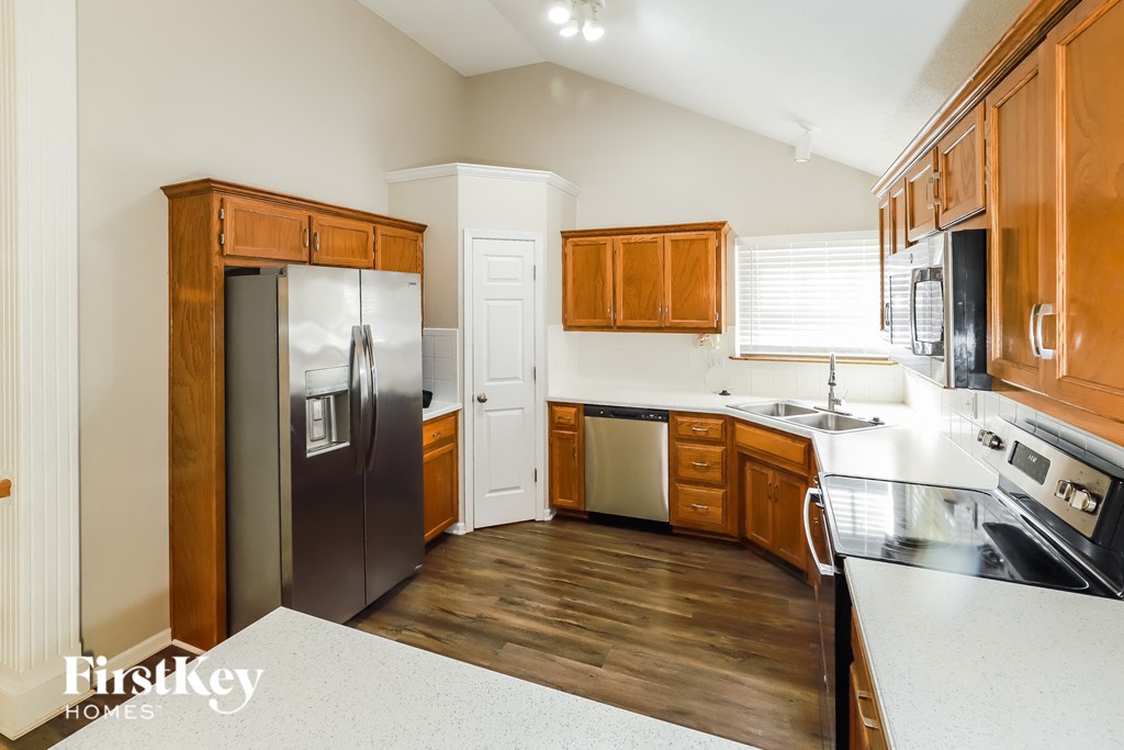 a kitchen with wooden cabinets and stainless steel appliances