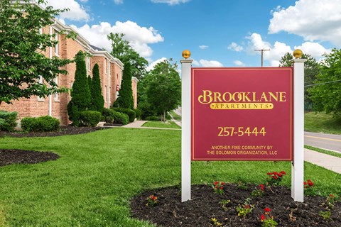 a sign in front of a brick building