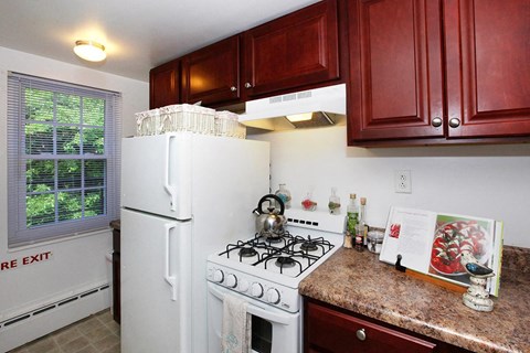 a kitchen with a white stove and a refrigerator