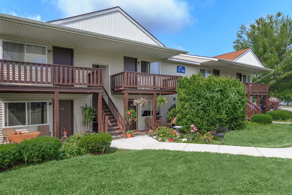 the front of a house with a sidewalk in front of it