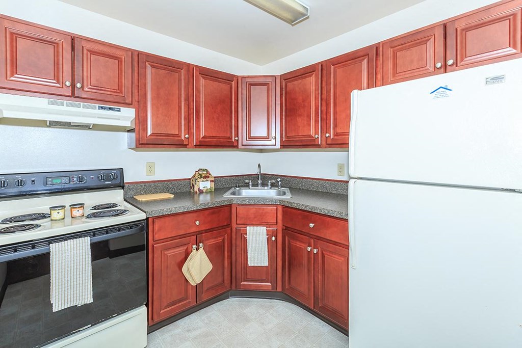 a kitchen with wooden cabinets and a white refrigerator