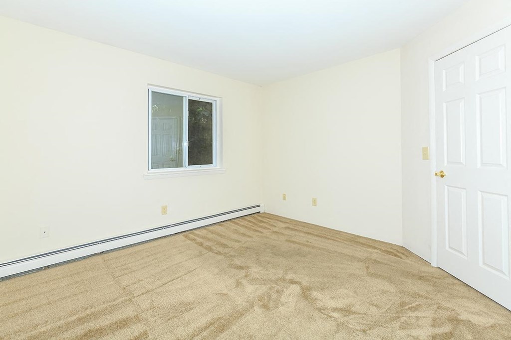 a room with carpet and a window and a door