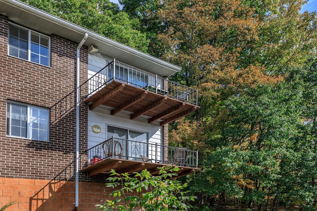 a balcony on the side of a brick building
