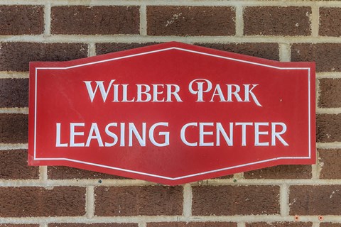 a red sign on a brick wall saying wildlife park leasing center