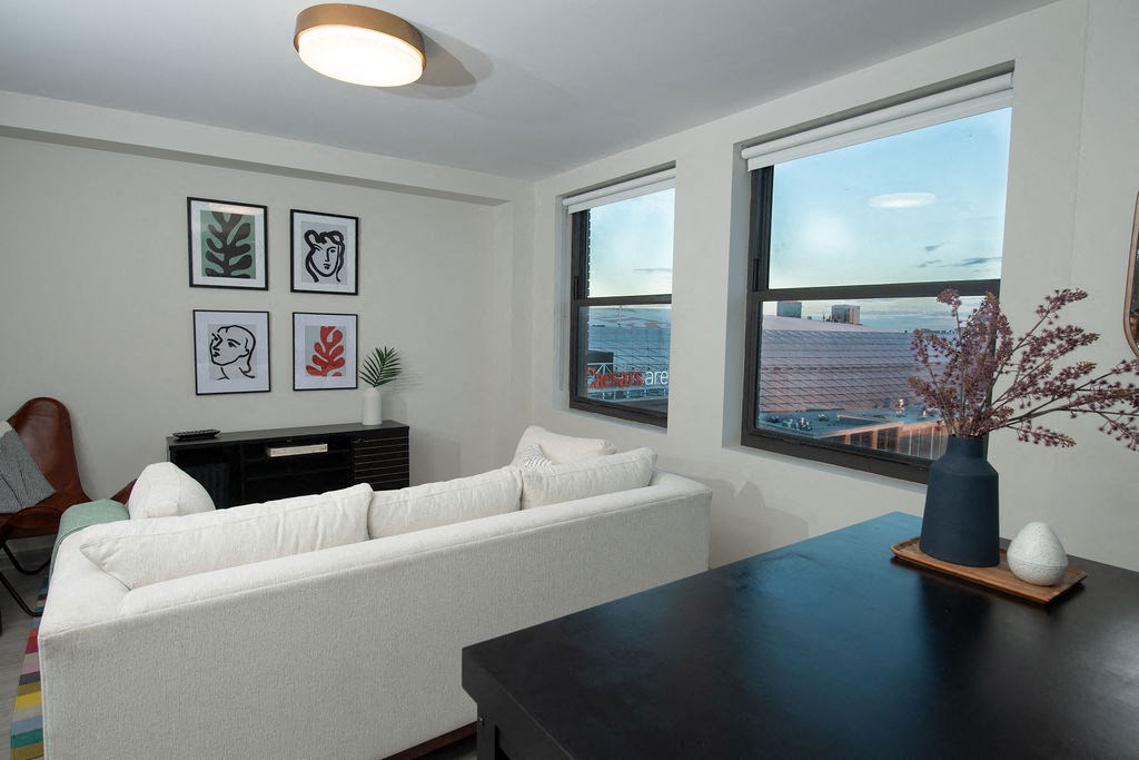 a living room with a black table and a white couch