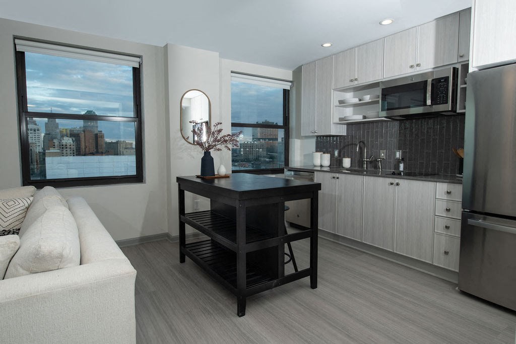 a kitchen and living room with a large window