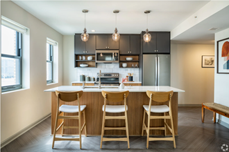 a kitchen with a bar and stools in a house
