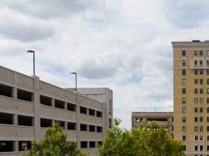 an empty parking lot in front of a tall building