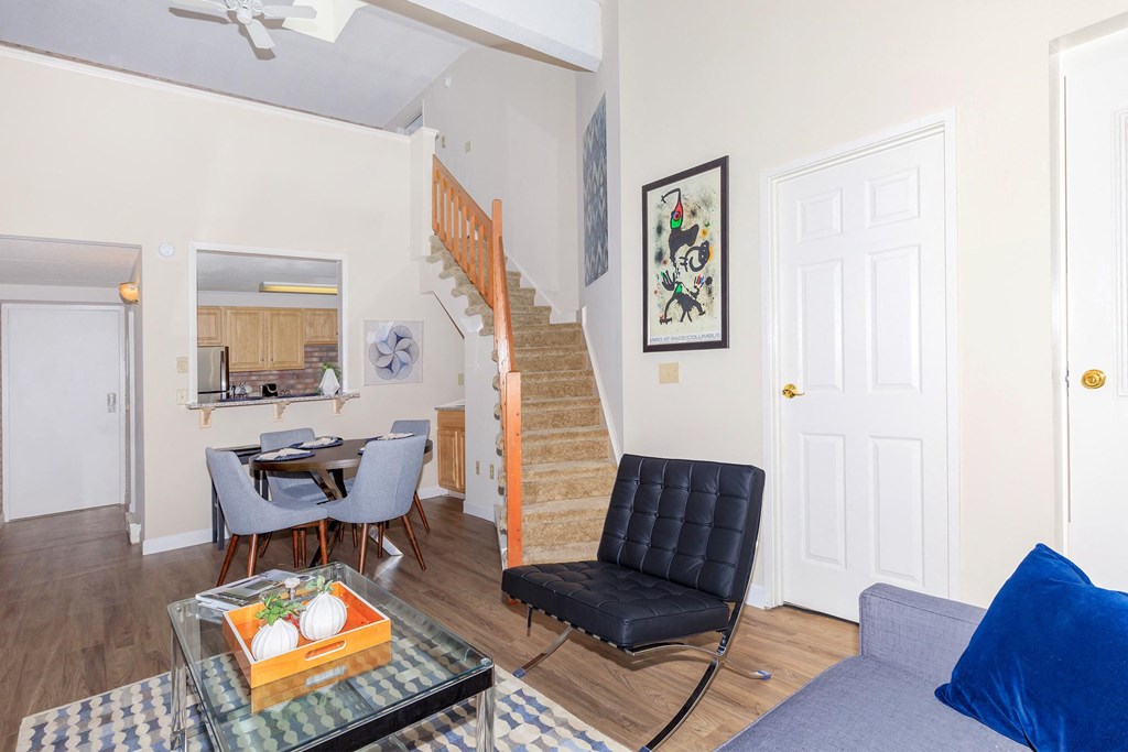 a living room with a couch and a table and a staircase