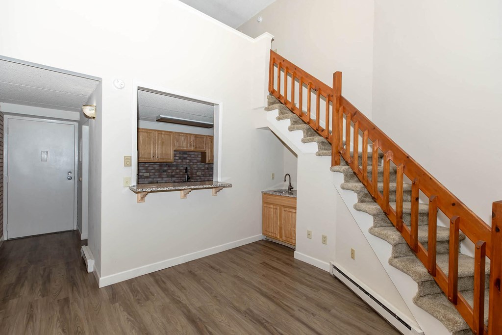 a stairway in a home with a door to a bathroom and a hall way