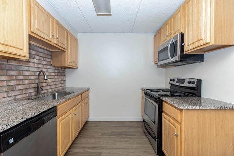 a kitchen with wood cabinets and appliances and a counter top